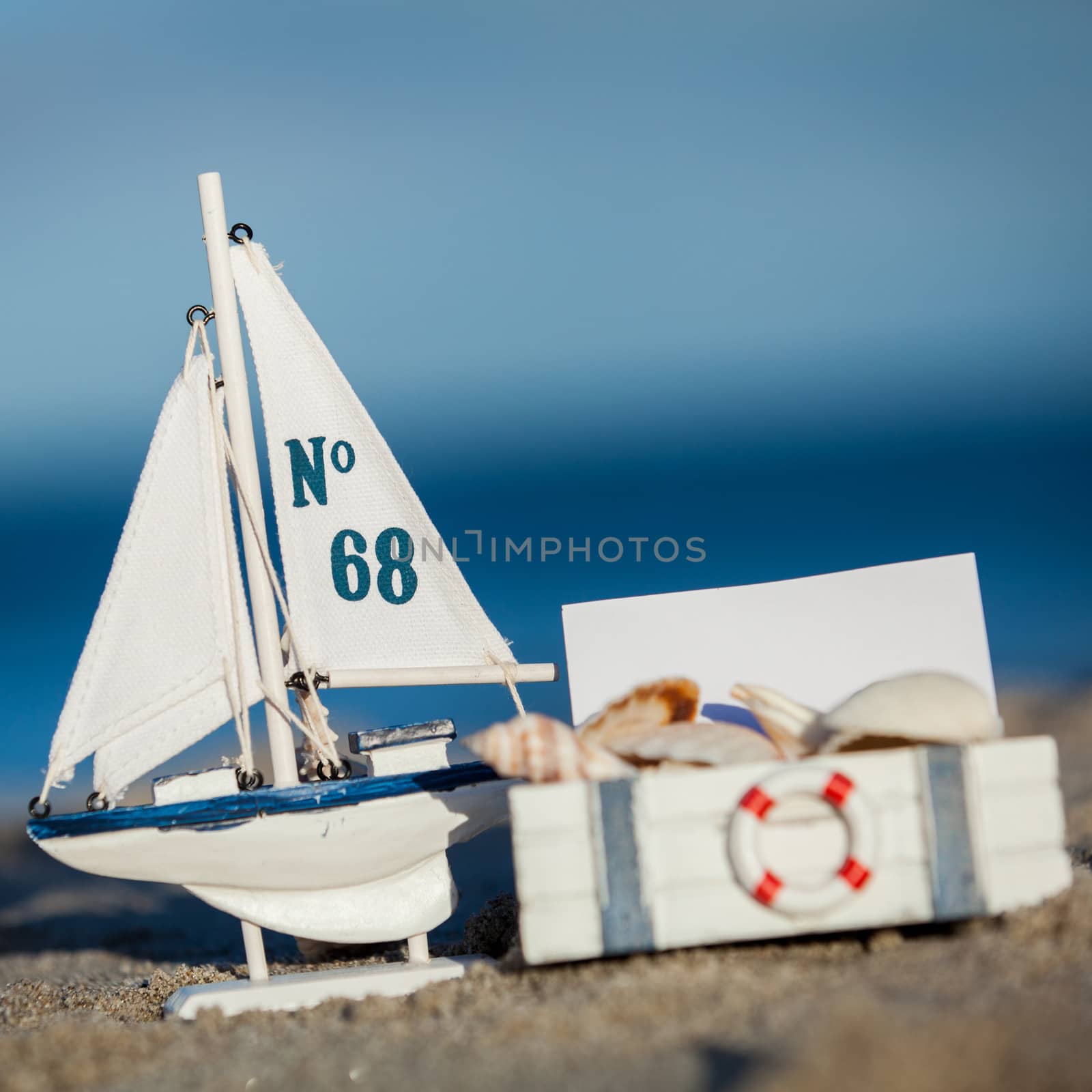 sailing boat and seashell in sand decoration closeup holiday background