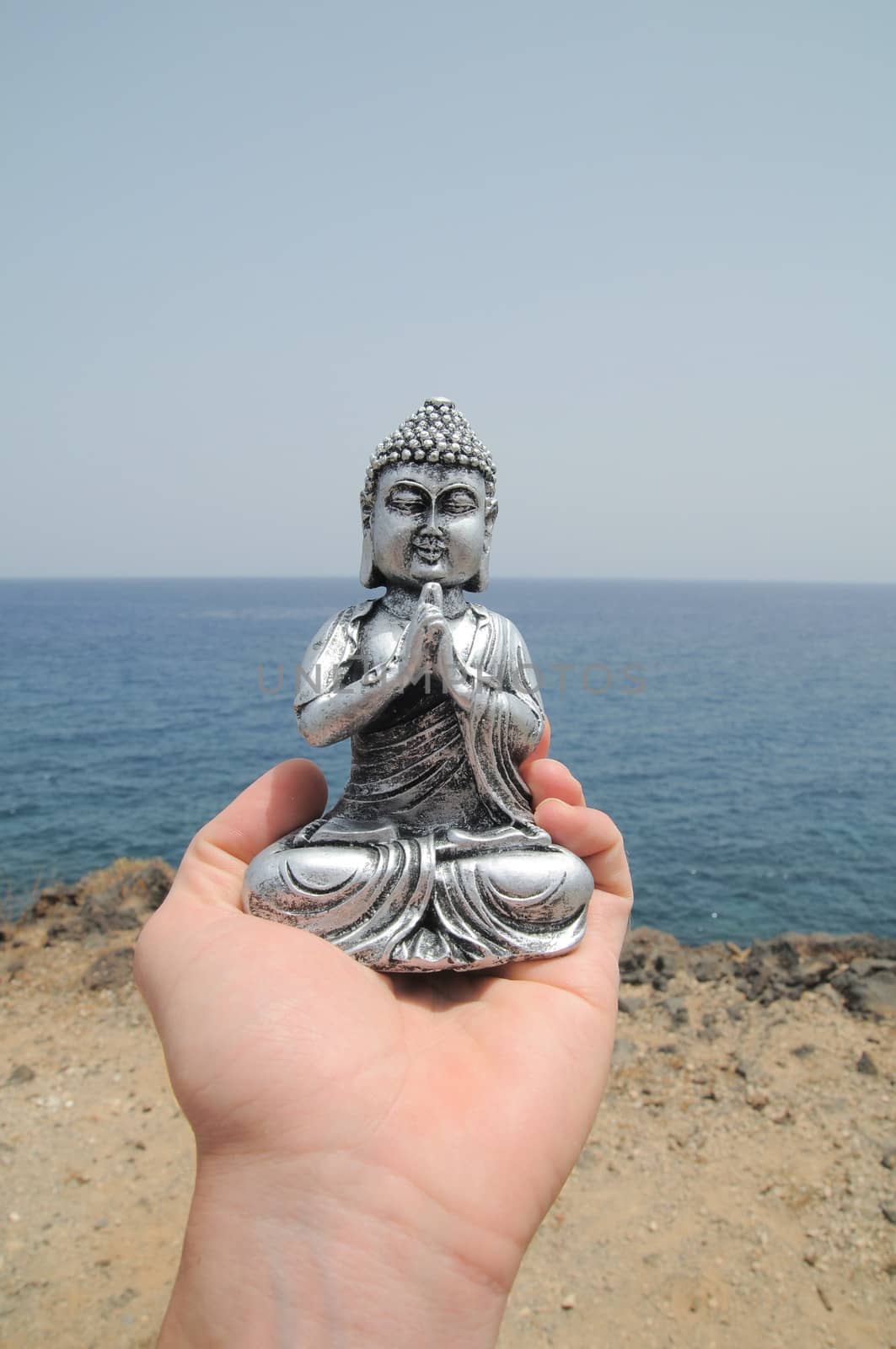 One Ancient Gray Buddha Statue Near The Ocean