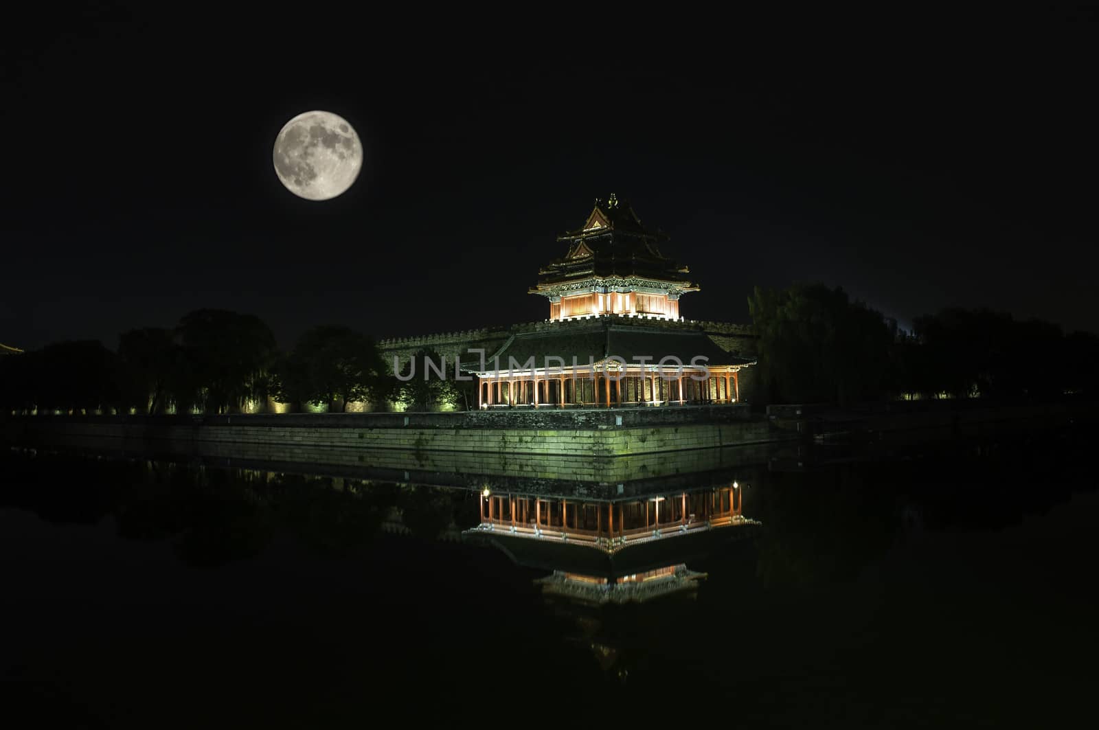 The watchtower of the Forbidden City under the moon light in Beijing, China