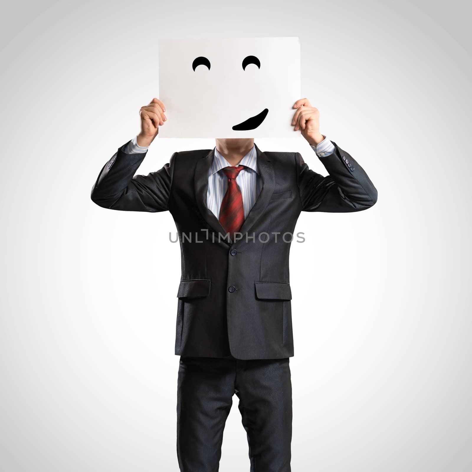 business man holding a poster with a painted face on it instead of a face, the concept of duplicity in business