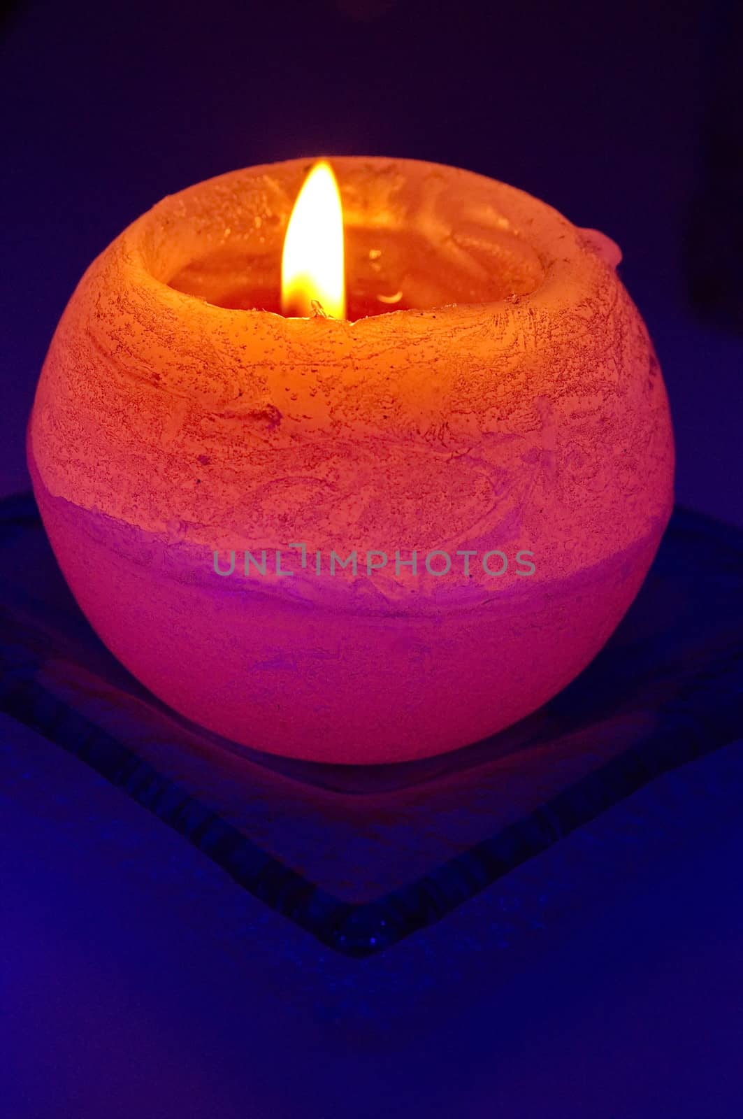 Orange candle on blue background