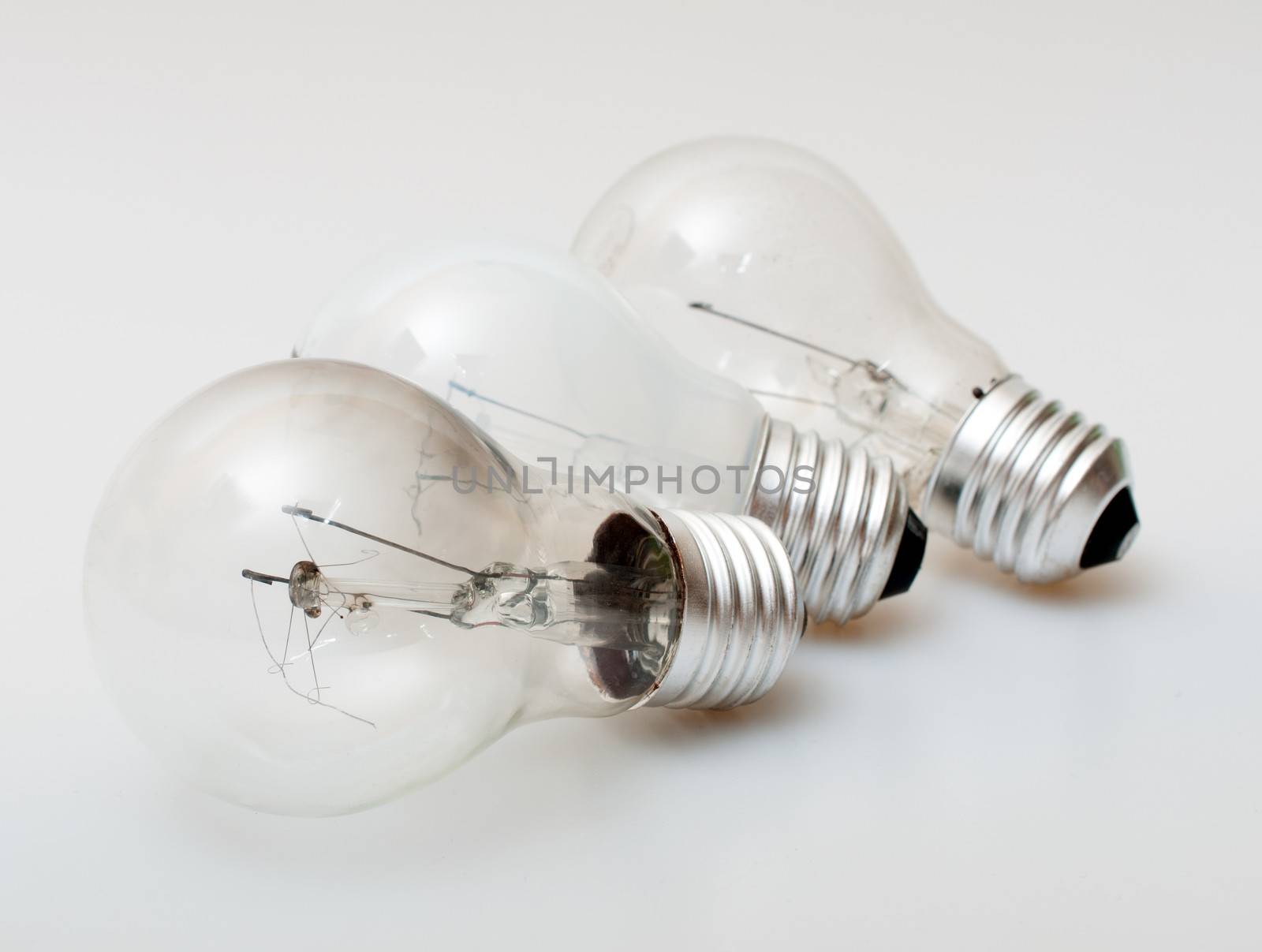 Three Aged Burnt Bulbs on Light Background - Shallow Depth of Field
