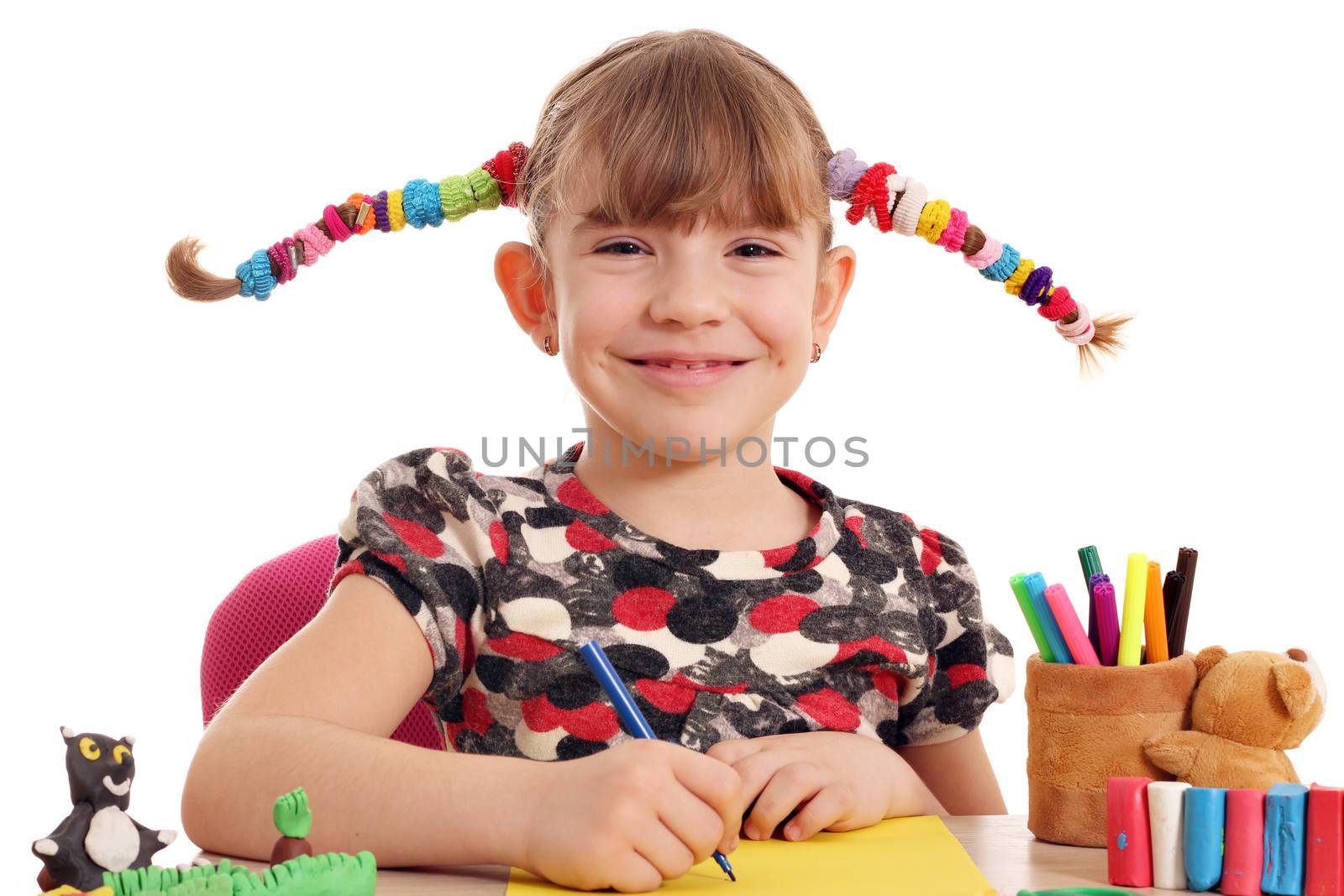 happy little girl with pigtails drawing