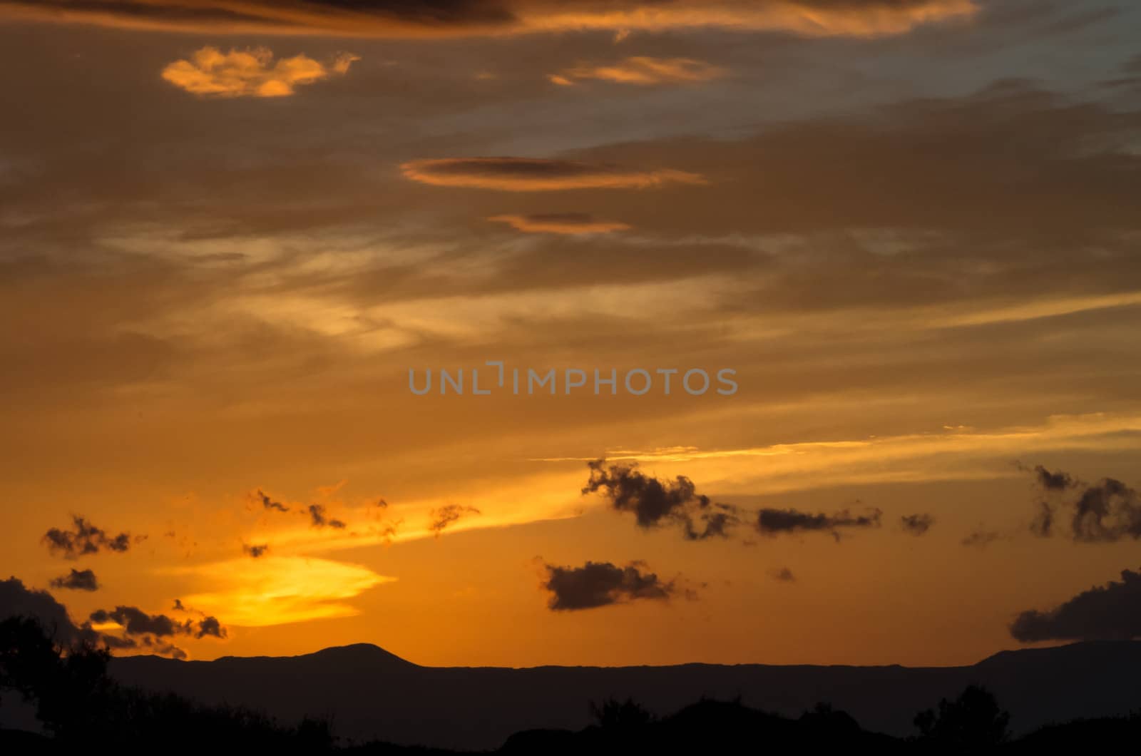 Clouds playing with orange,red and pink colors at sunset in Crete