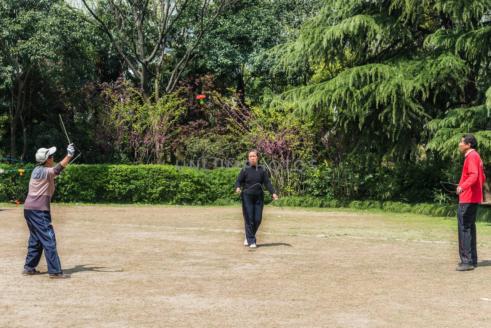 Shanghai, China - April 7, 2013: old people playing diabolo in fuxing park at the city of Shanghai in China on april 7th, 2013