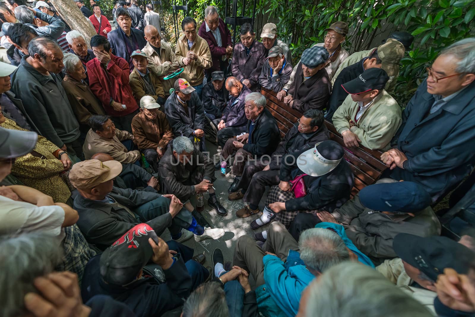 Shanghai, China - April 7, 2013: group of people discussing in fuxing park at the city of Shanghai in China on april 7th, 2013