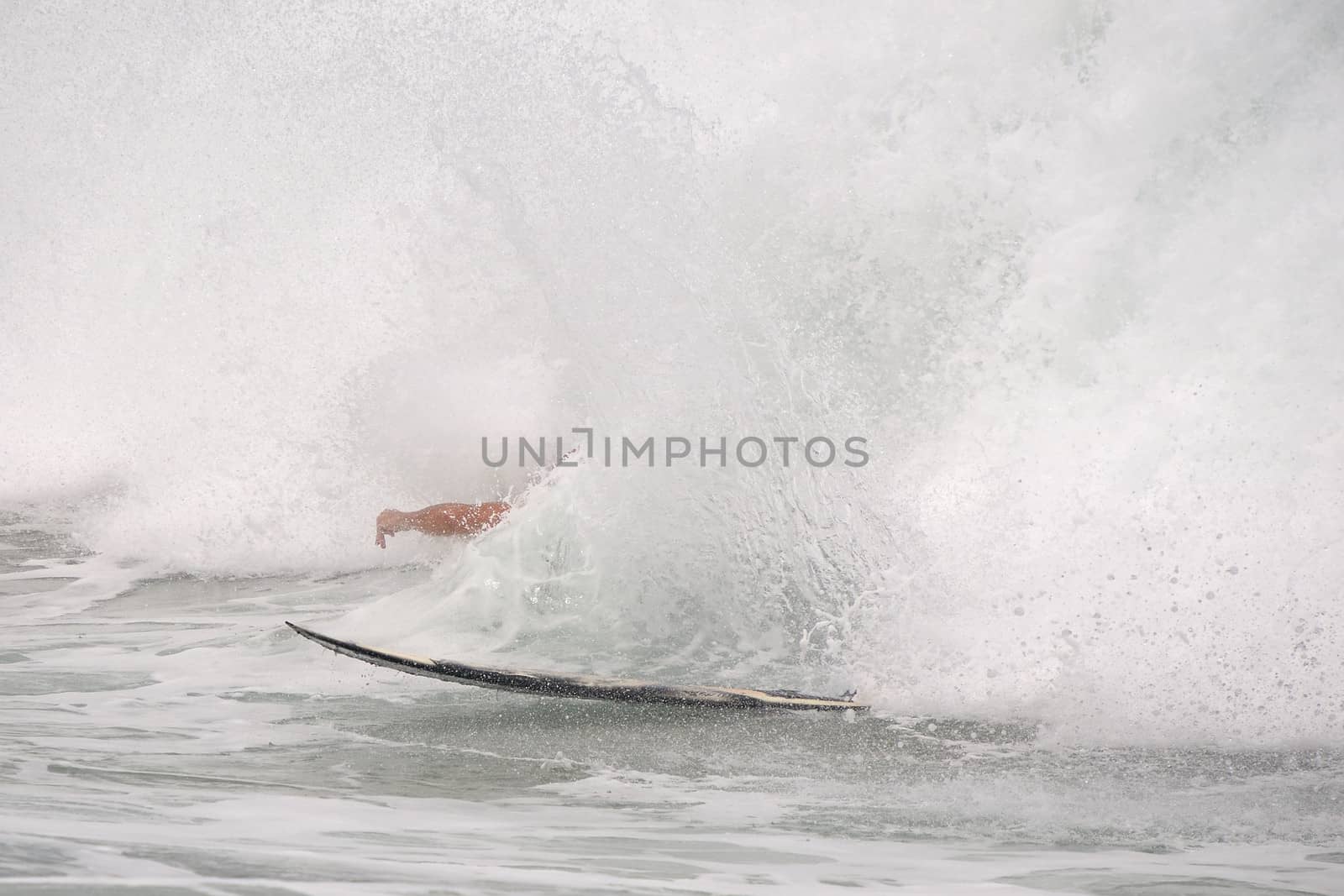 Surfer knocked by huge wave from surfboard