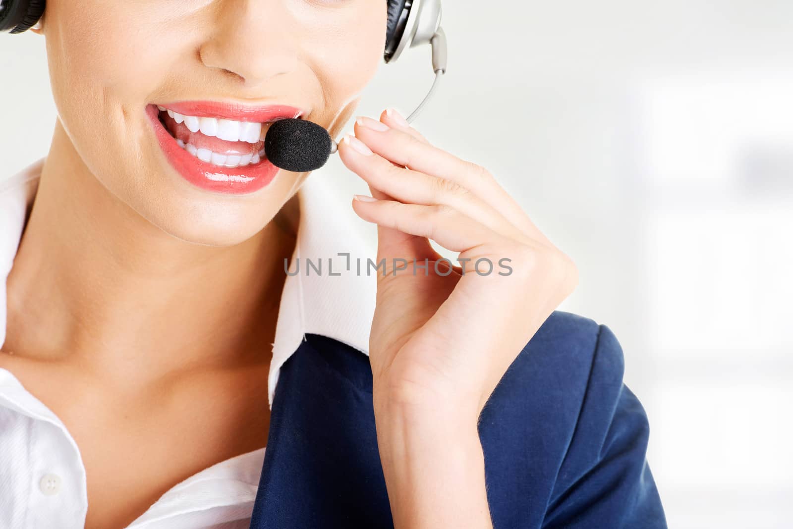 Pretty call-centre assistant smiling at the camera by BDS