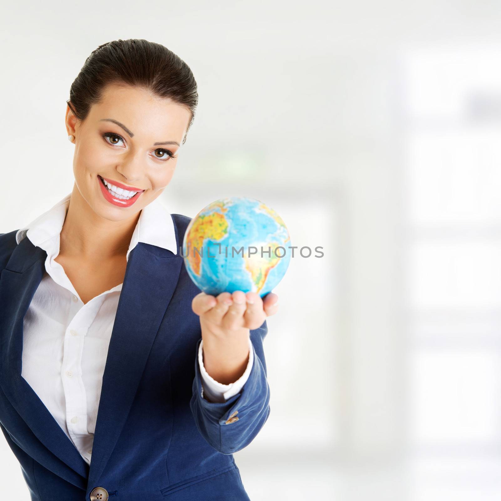 Young businesswomen with globe by BDS