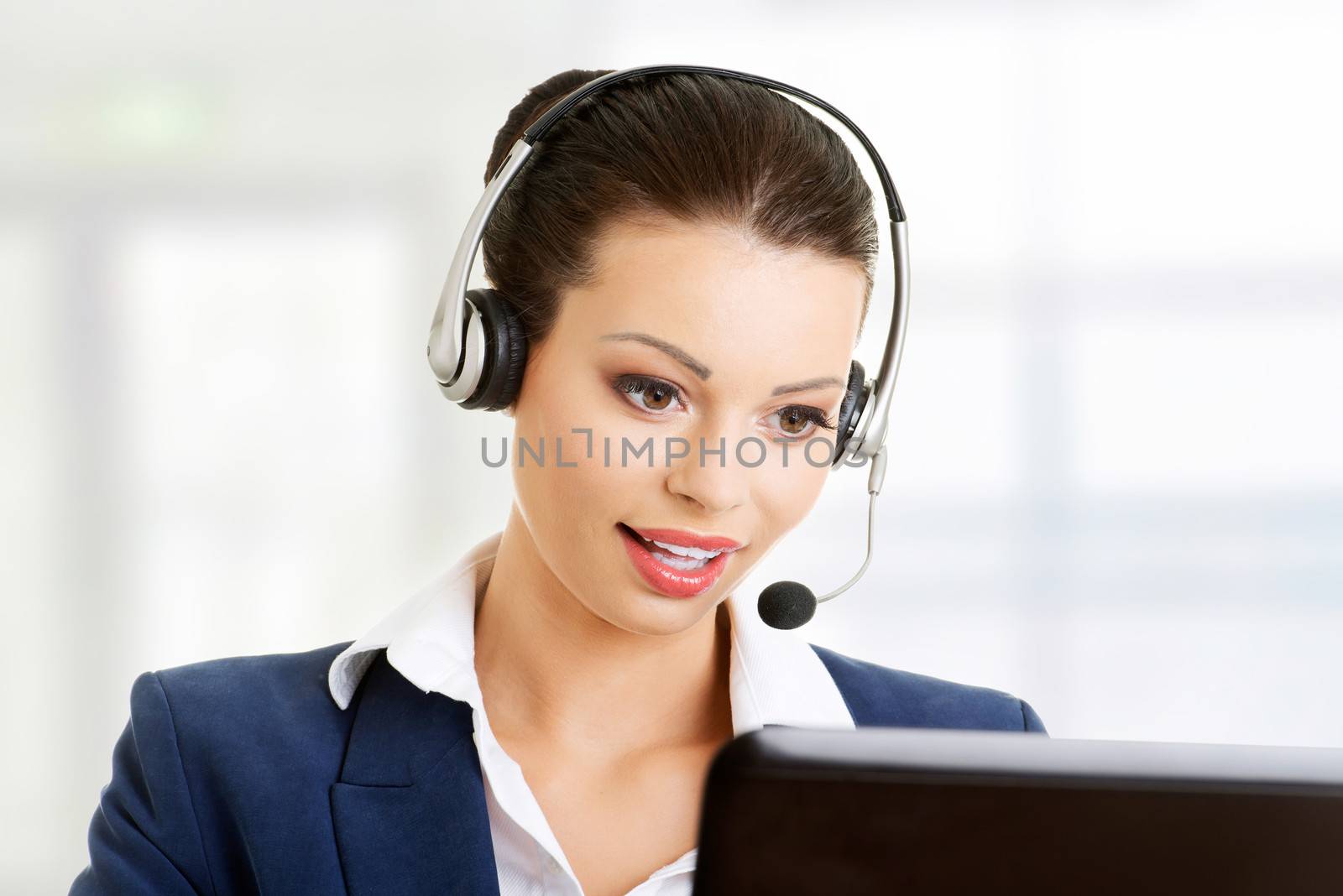 Beautiful young call-center assistant smiling by BDS