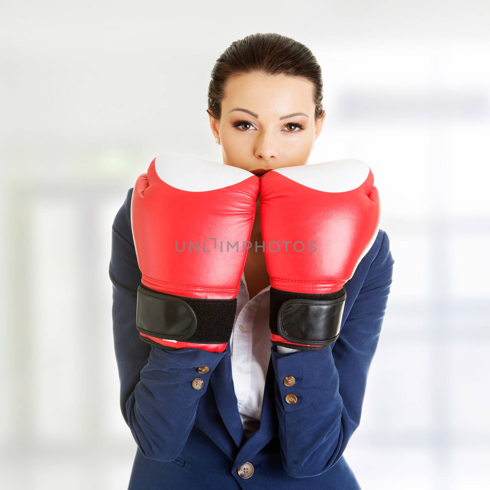 Young businesswoman with boxing gloves by BDS