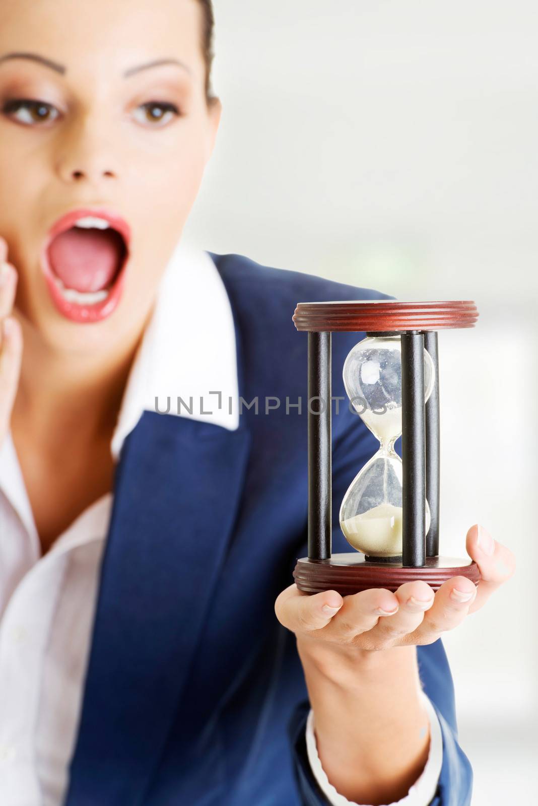 Young business woman with hourglass - time concept by BDS