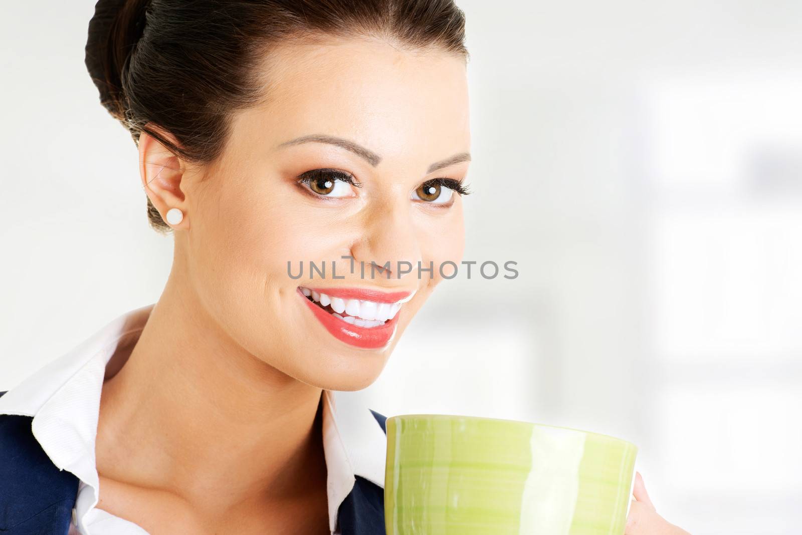 Smiling businesswoman having coffee break by BDS