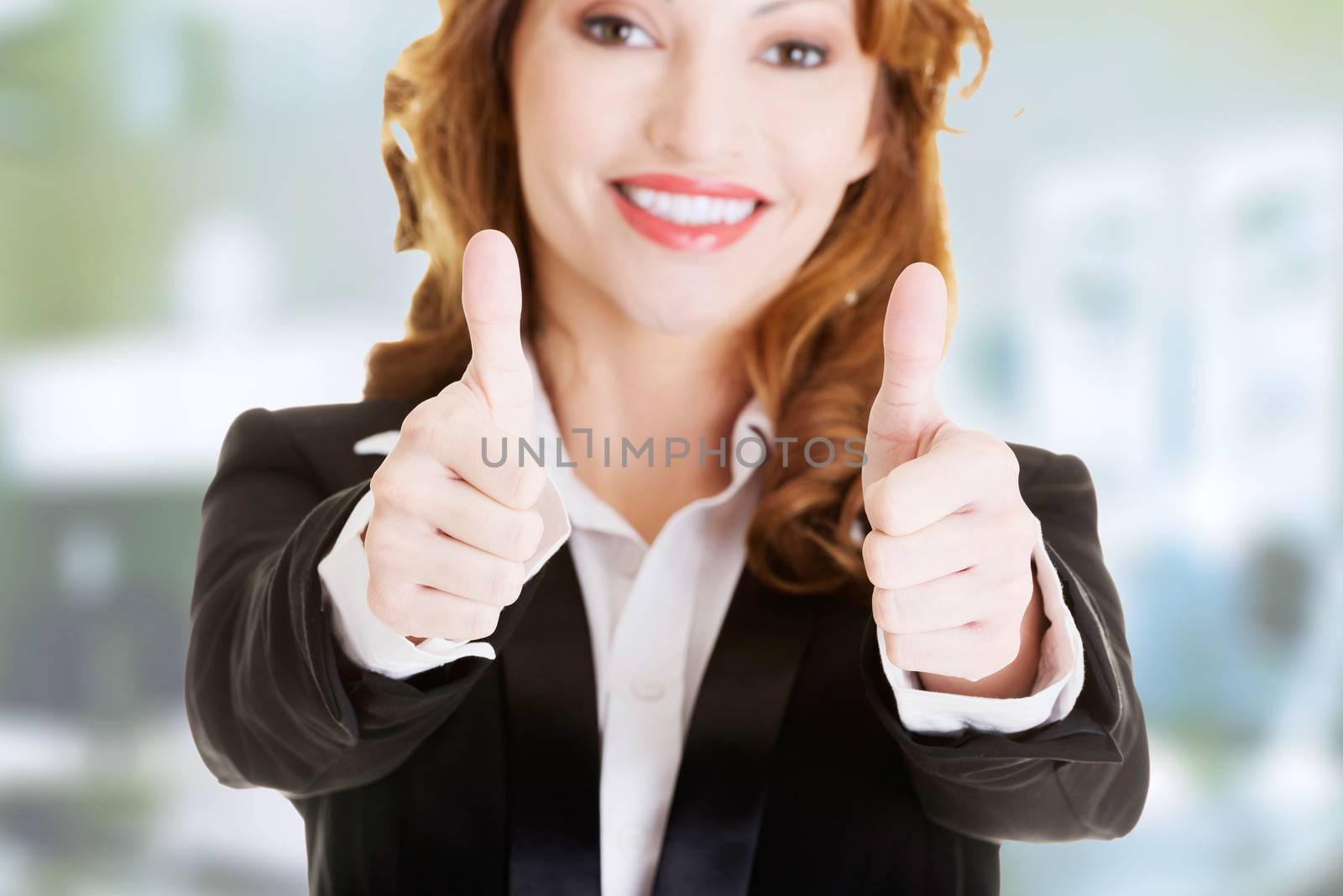 Happy smiling business woman with thumbs up, ok gesture