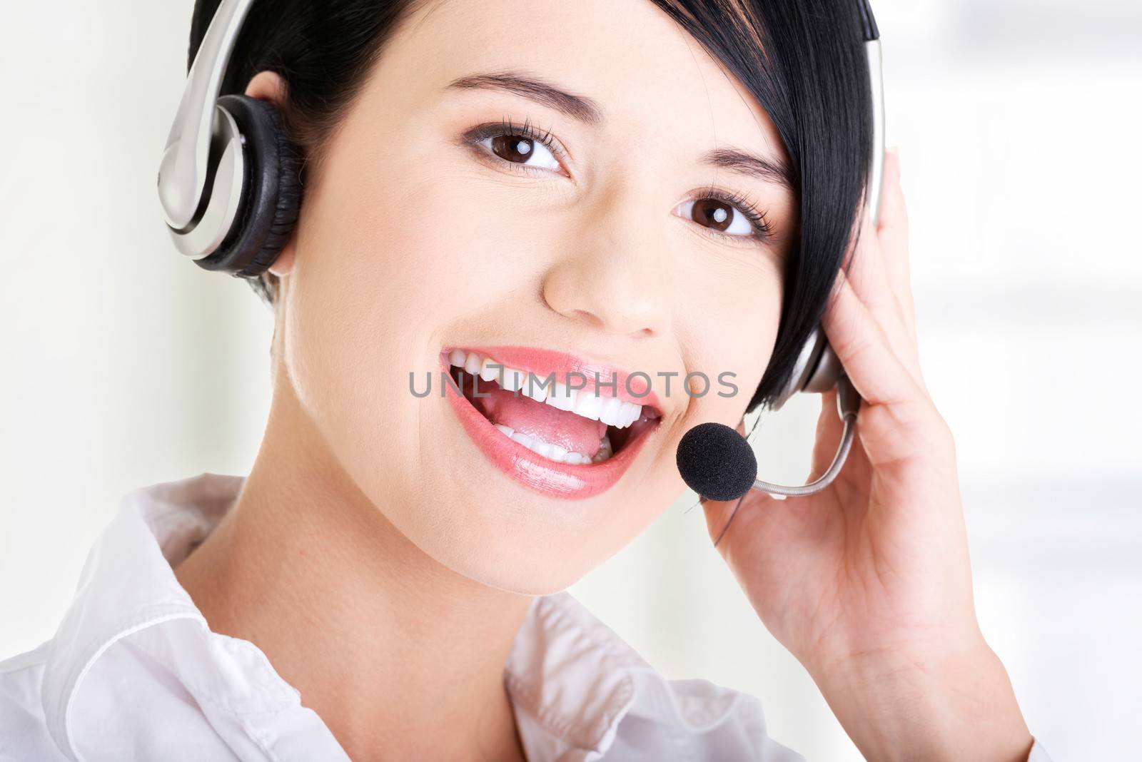Beautiful young call-center assistant smiling at the camera