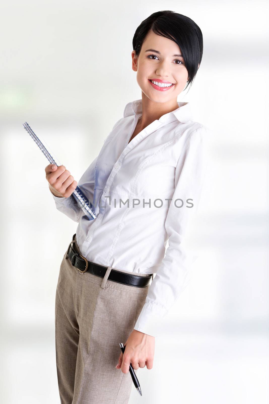Happy smiling business woman holding notebook and pen by BDS