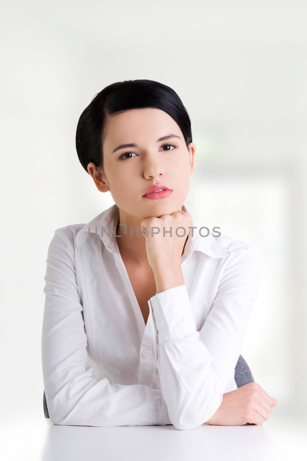 Pretty young woman in sitting at the desk by BDS