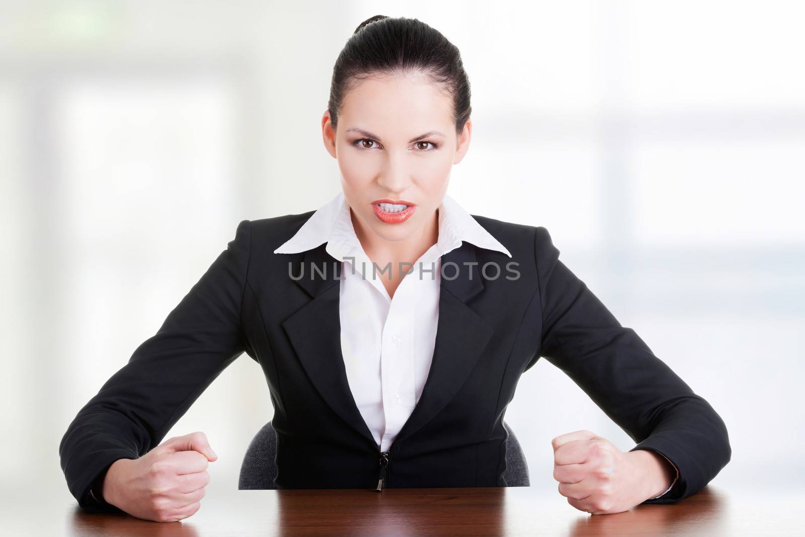 Angry businesswoman at the desk by BDS