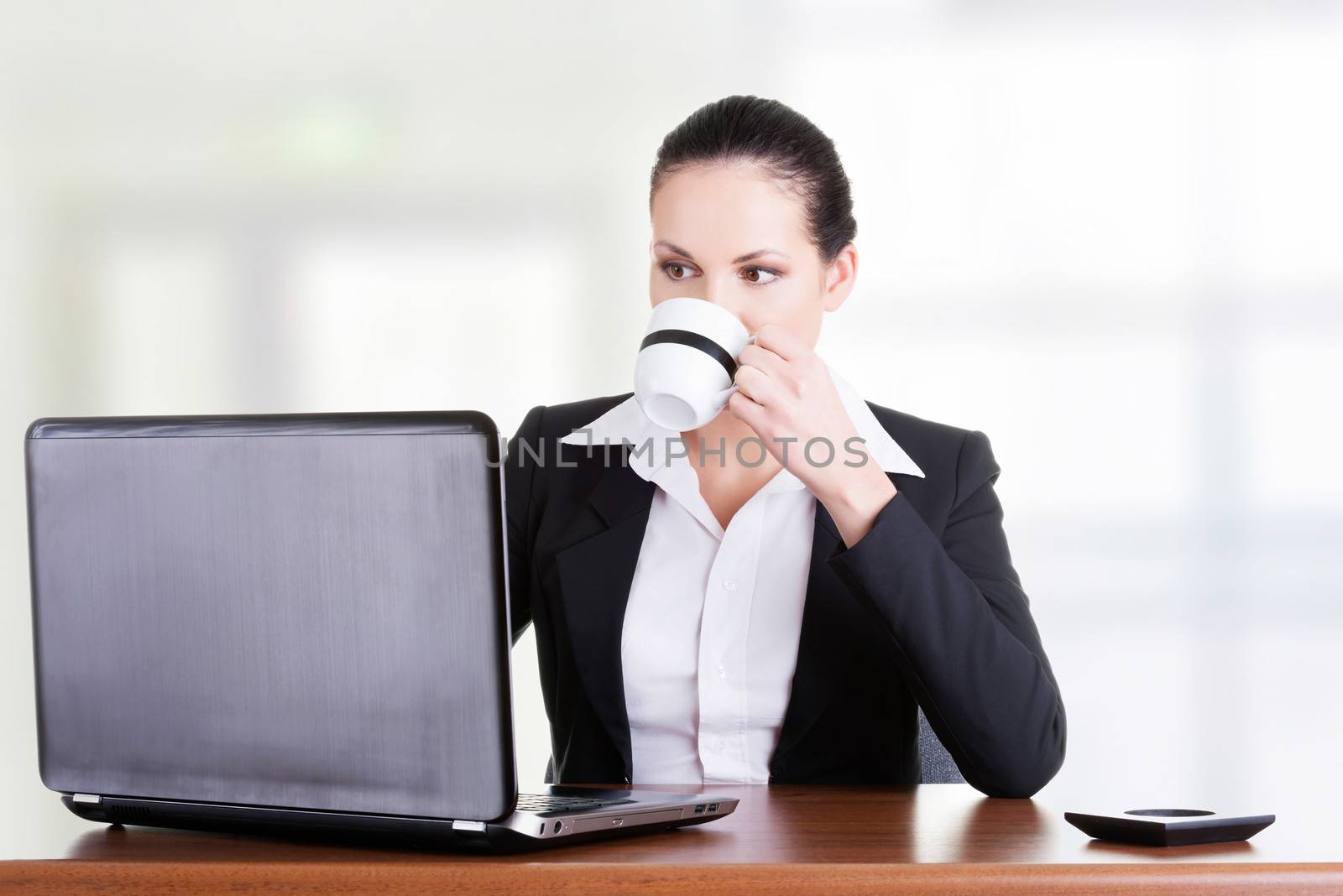 Beautiful brunette businesswoman working on laptop by BDS