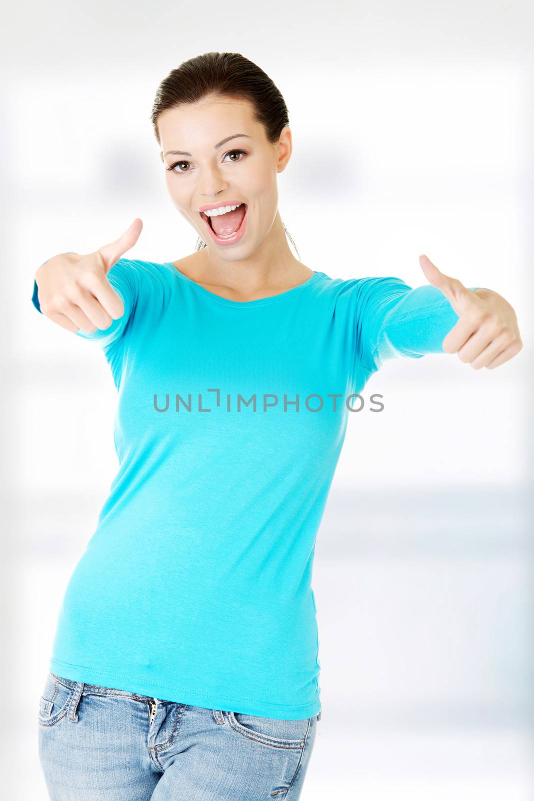 Woman in casual clothes gesturing thumbs up. by BDS