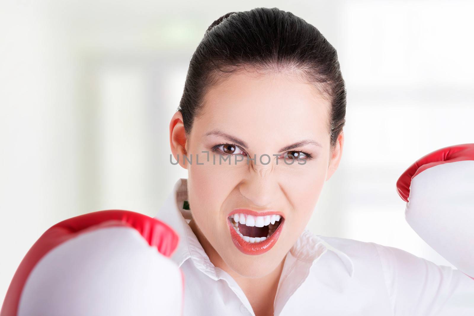 Young businesswoman with boxing gloves by BDS