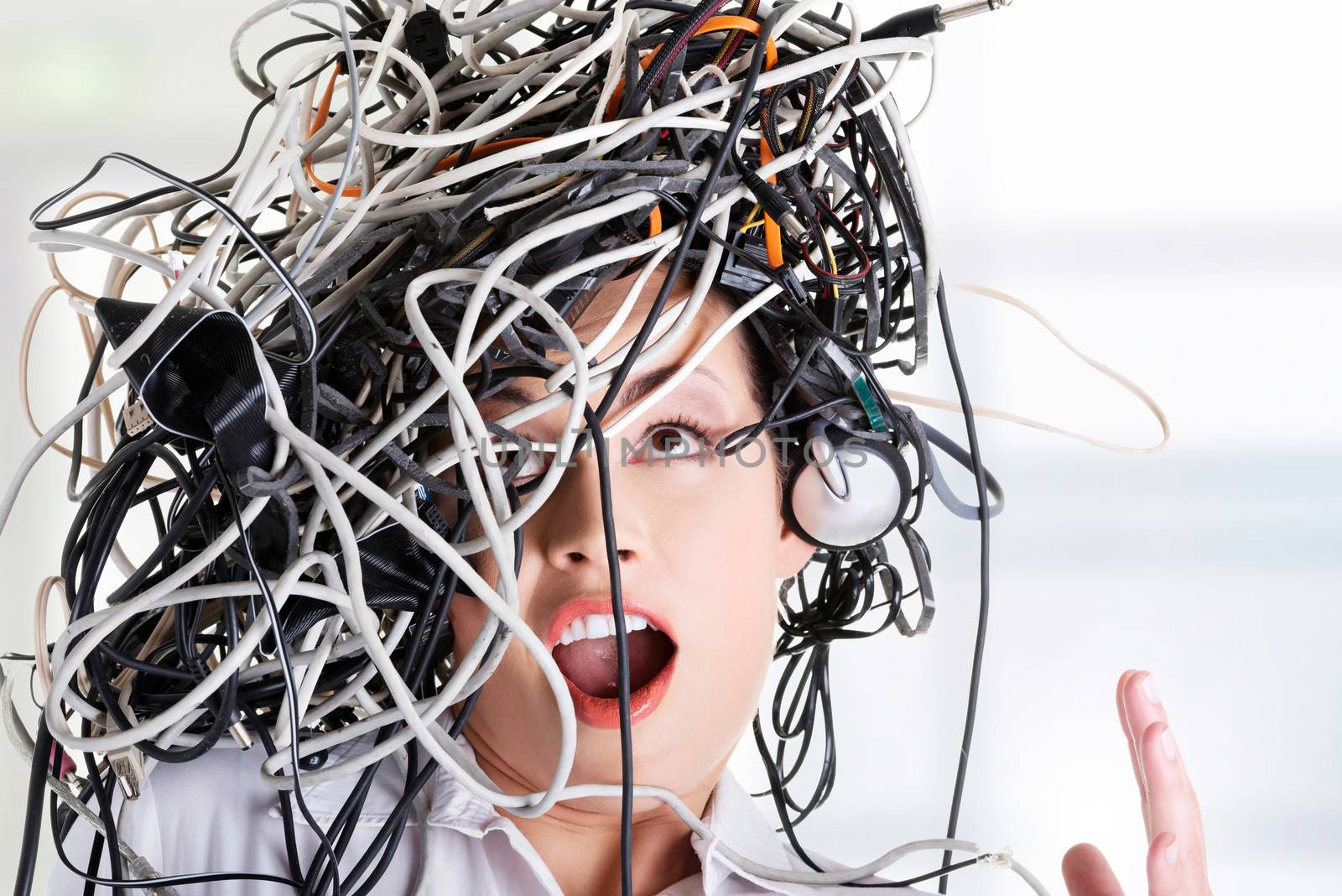 Troubled shocked businesswoman with cables on head