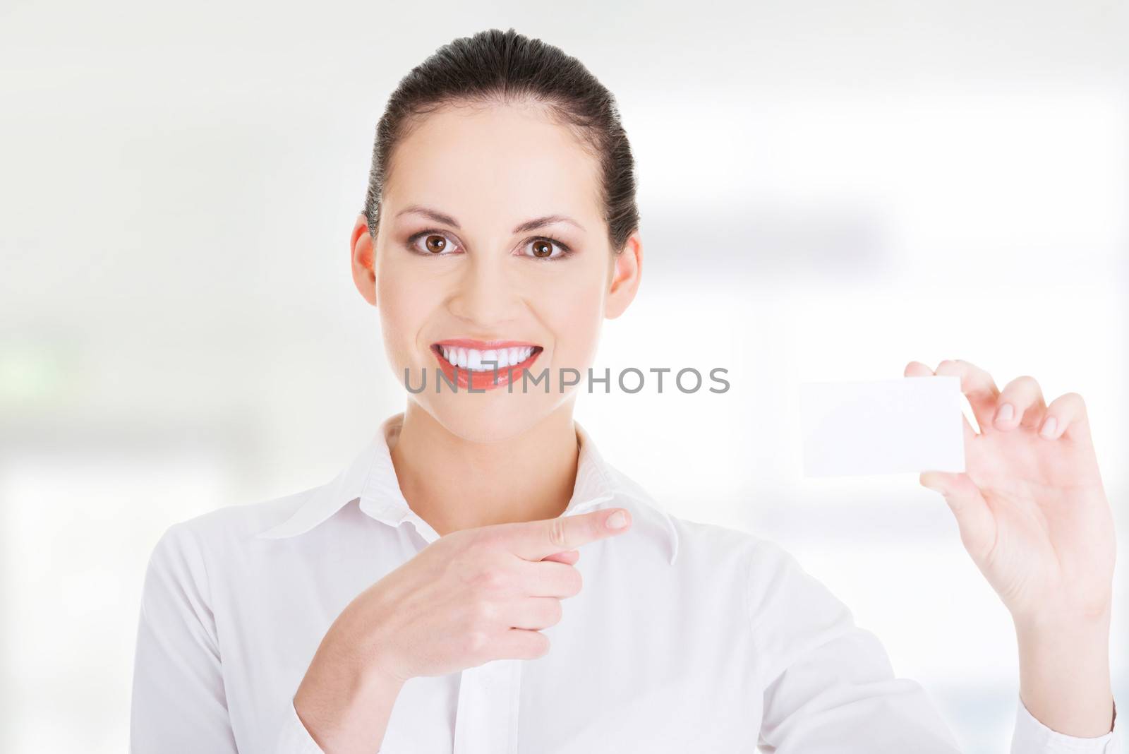 Beautiful smiling businesswoman with businesscard. Isolated on white