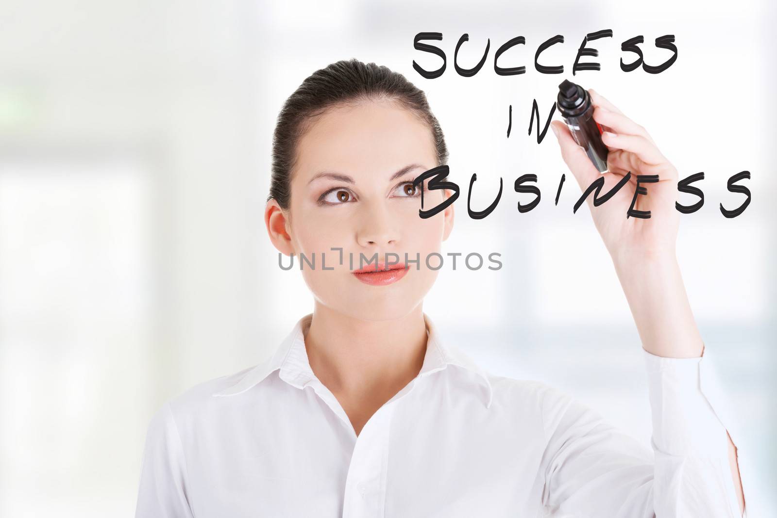 Young businesswoman writing something on abstract screen
