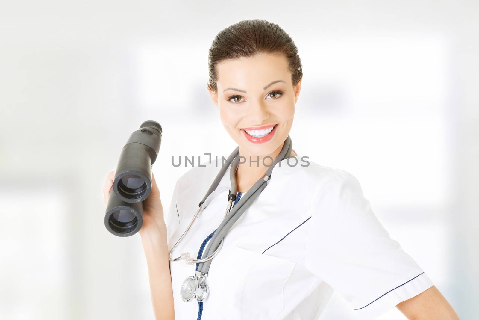 Female doctor or nurse looking through binoculars. by BDS