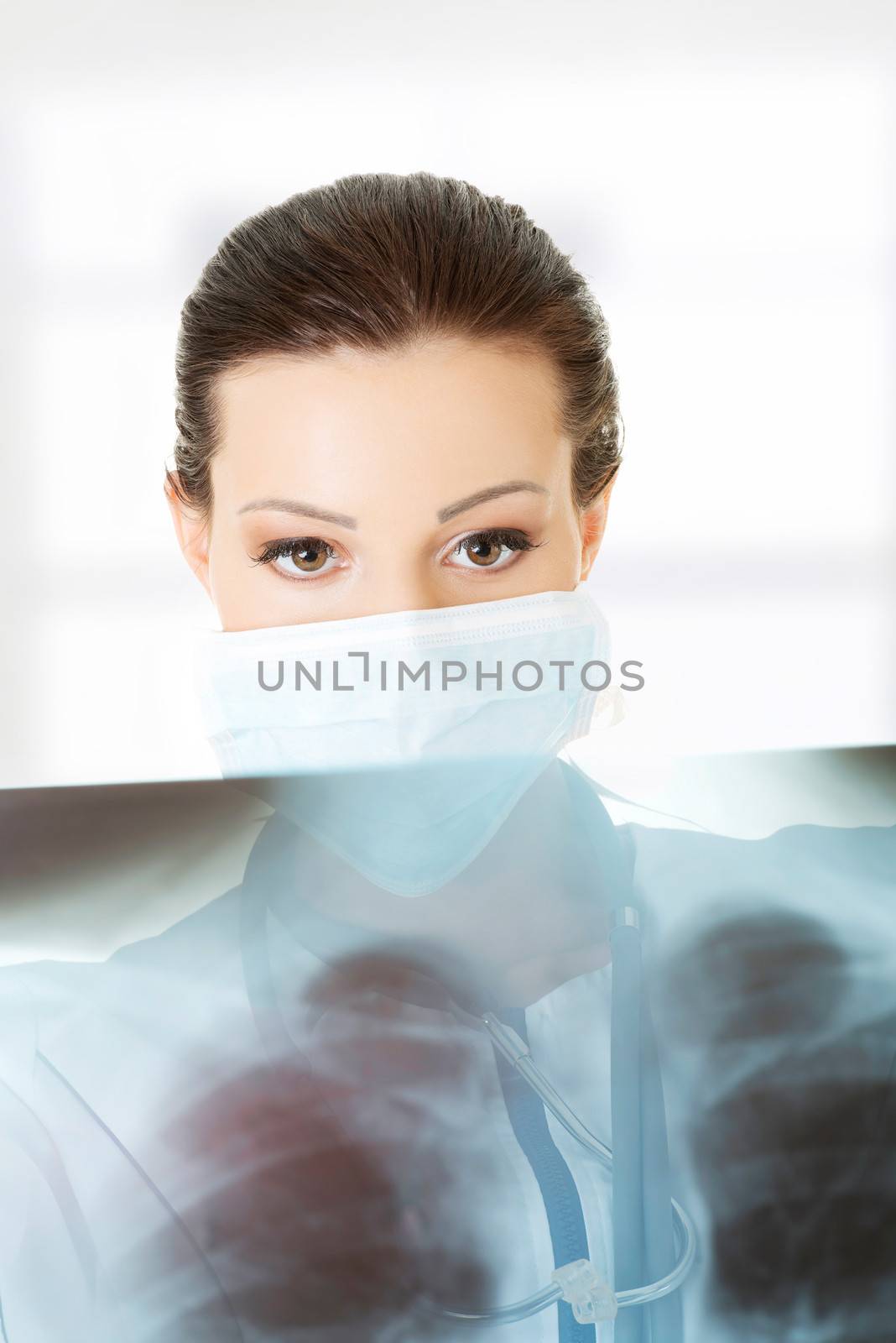 Female doctor or nurse looking at radiography photo , isolated on white