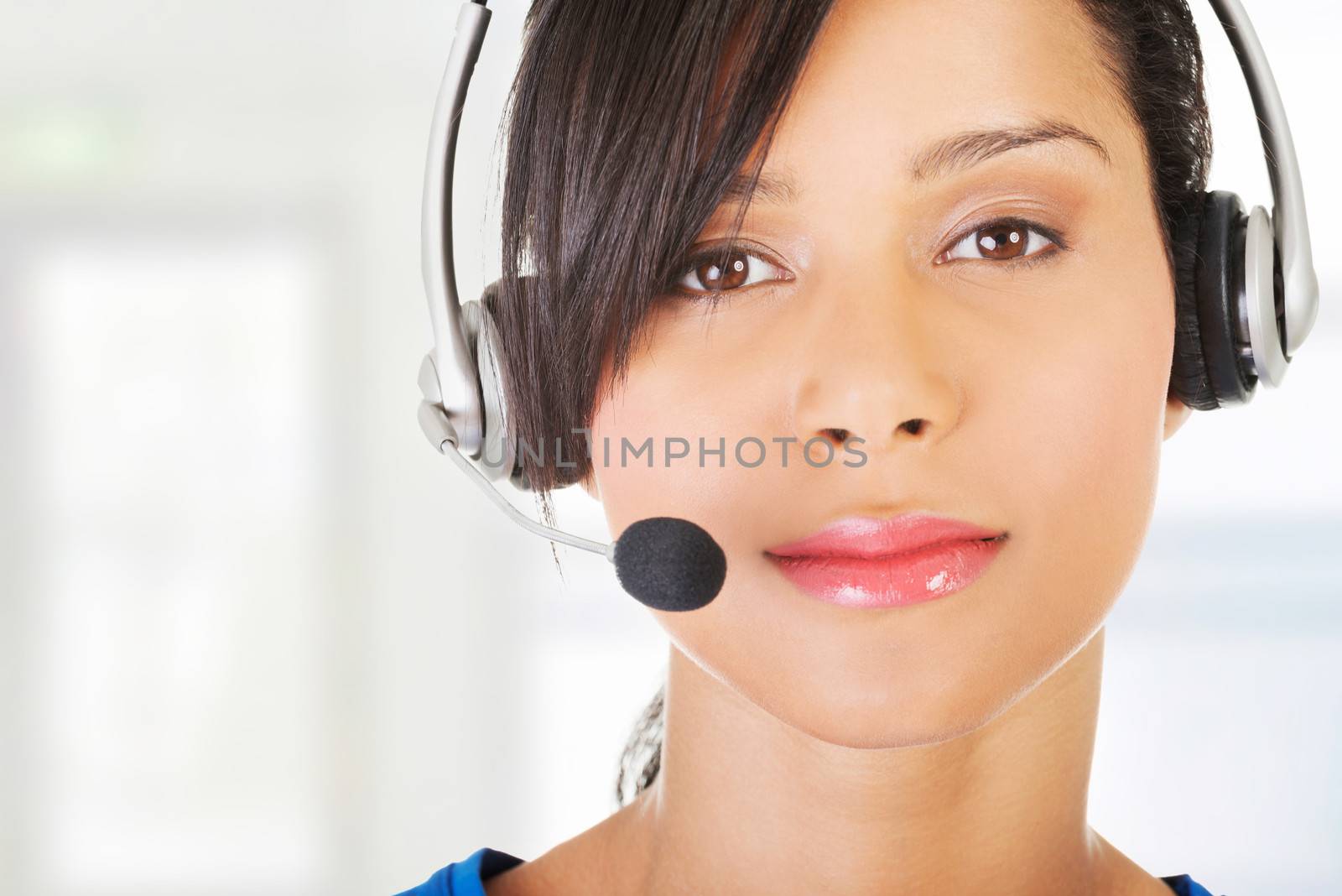 Beautiful young call-center assistant smiling , isolated