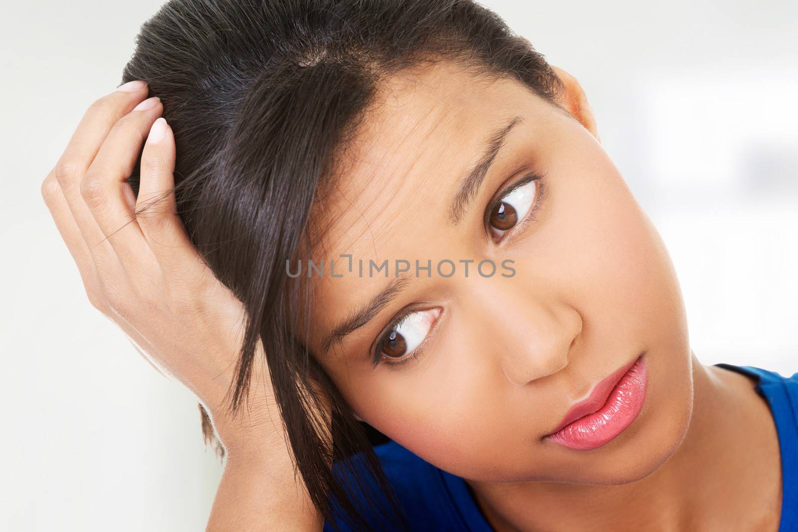 Young beautiful woman in depression. Isolated on white background.