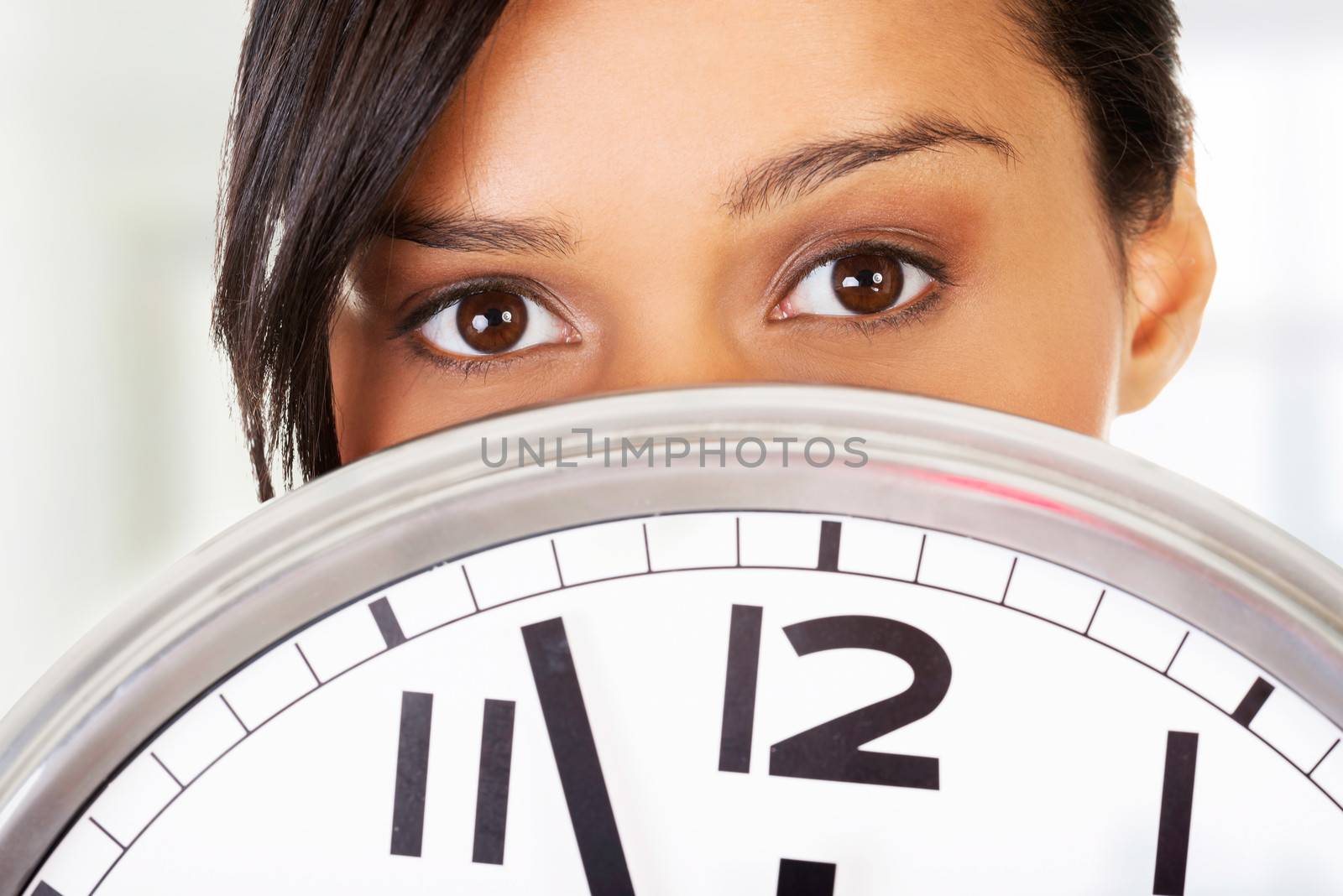 Portrait of shocked woman with clock by BDS