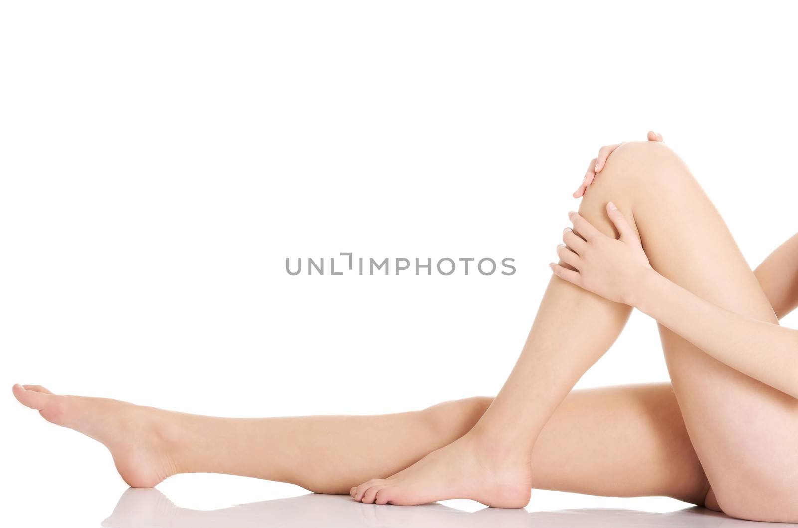 Beautiful and smooth woman's perfect legs with fresh skin. Isolated on white.