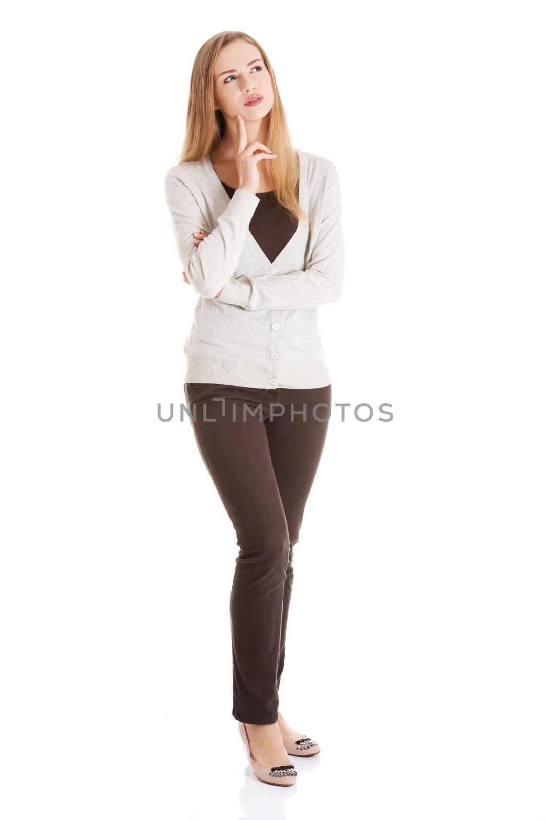Portrait of beautiful casual woman thinking. Isolated on white.