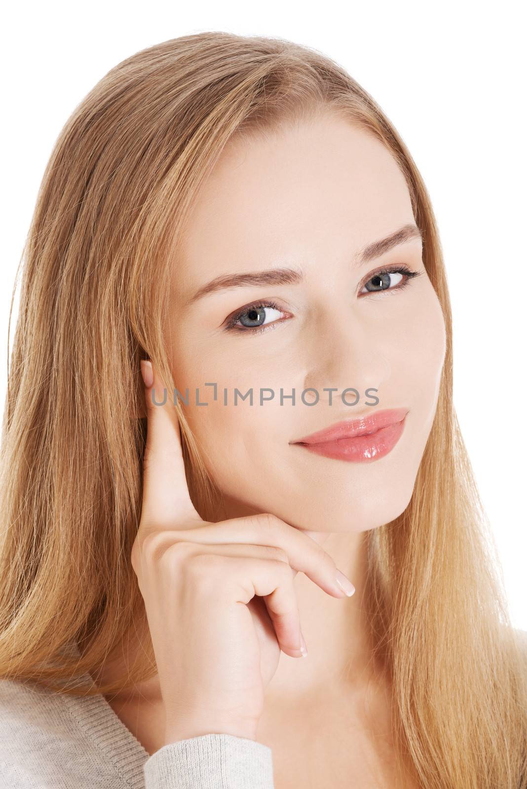 Portrait of beautiful smiling woman with her finger touching her face. Isolated on white.