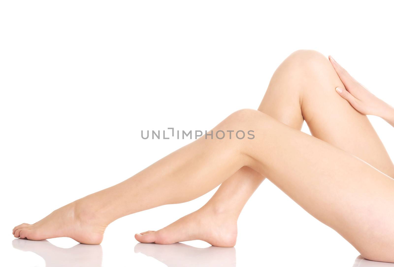 Beautiful and smooth woman's perfect legs with fresh skin. Isolated on white.