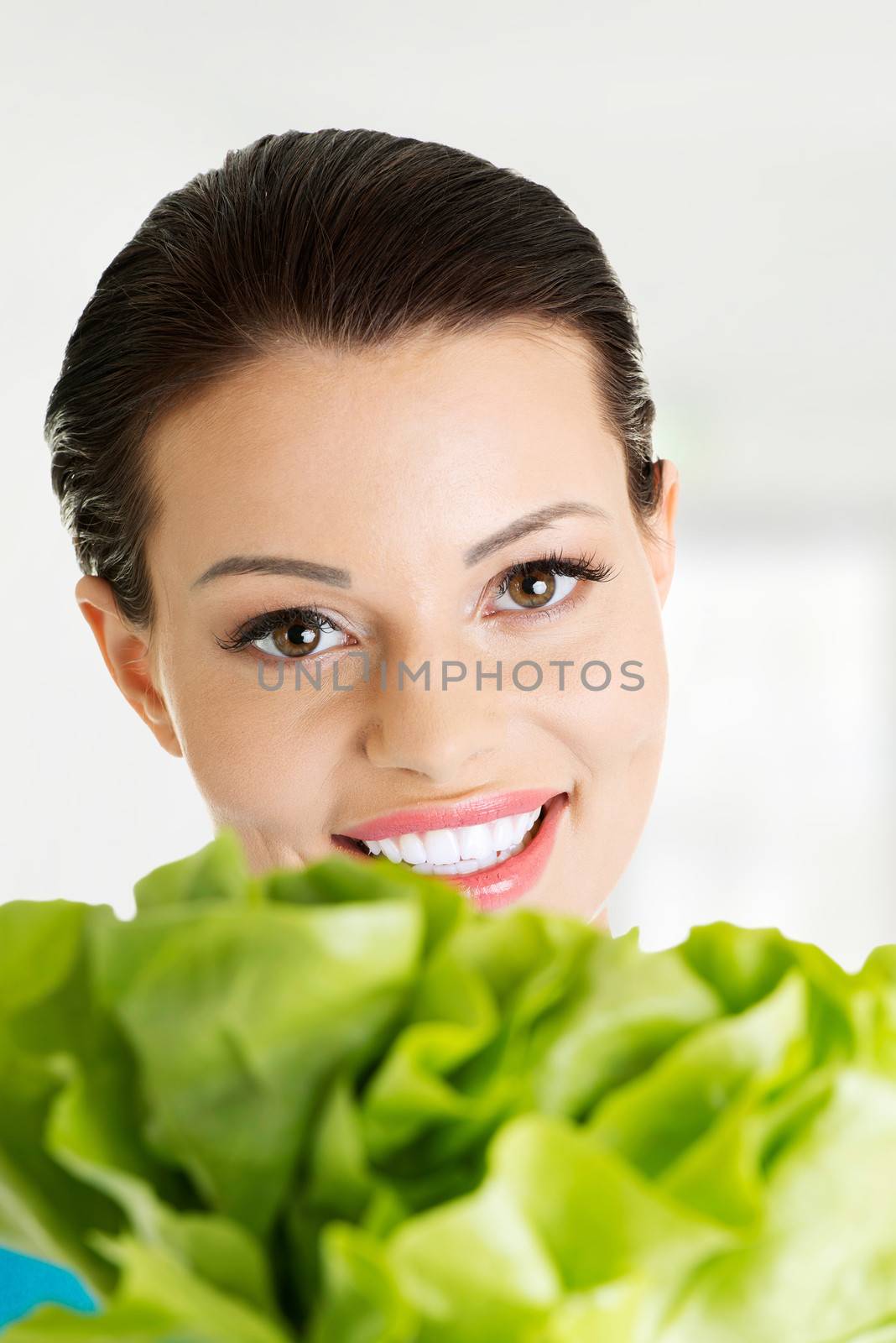 Portrait of attractive caucasian smiling woman with salat, isolated on white