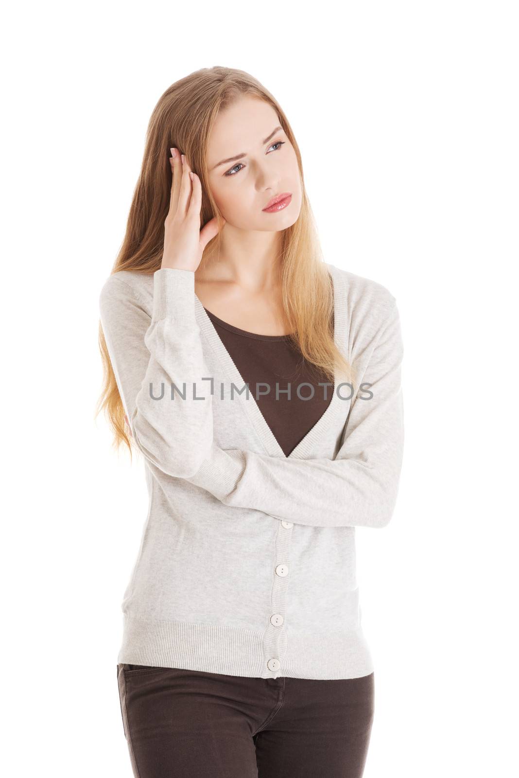 Beautiful casual woman looks worried. Isolated on white.