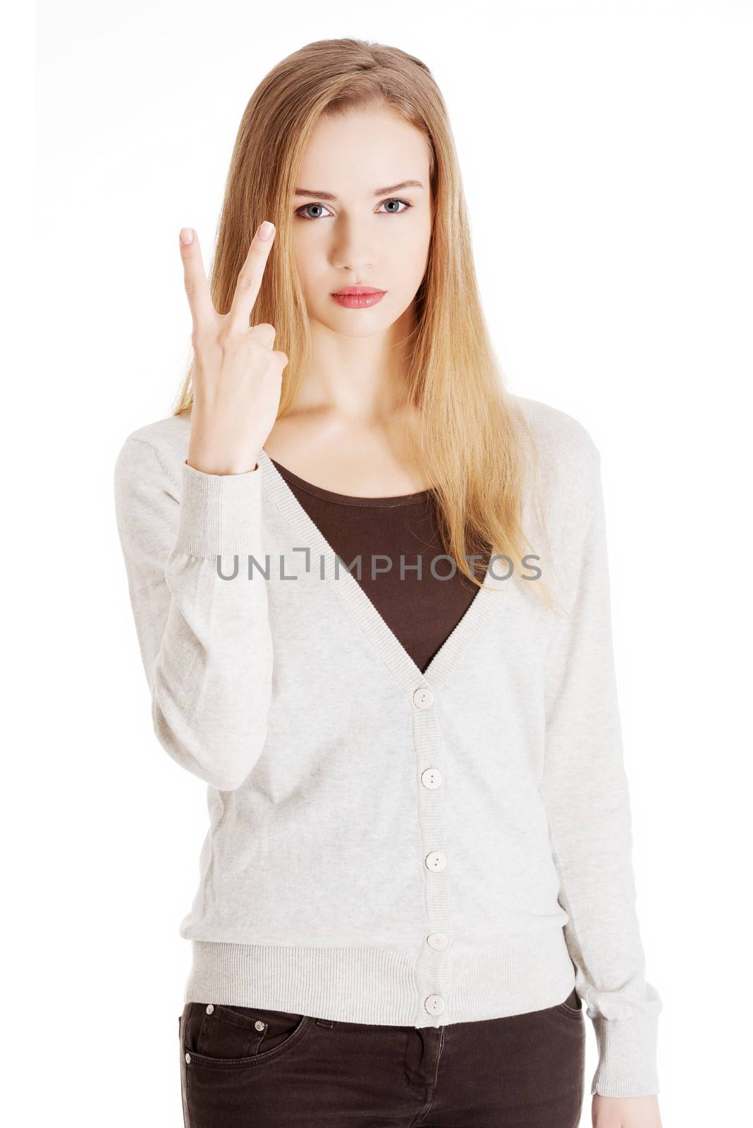 Beautiful casual woman is showing victory sign, two fingers. Isolated on white.