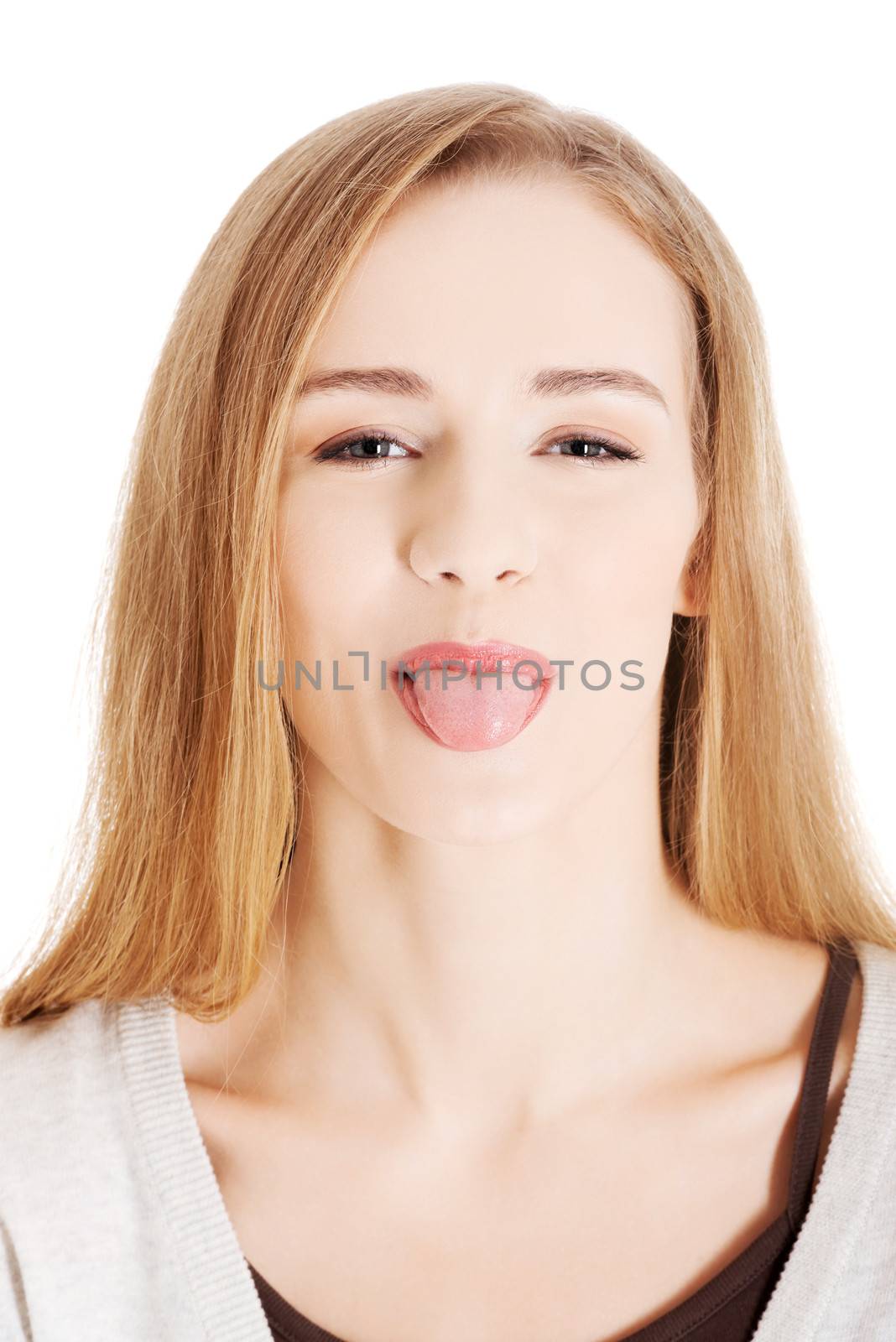 Beautiful blond woman showing her tongue. Isolated on white.