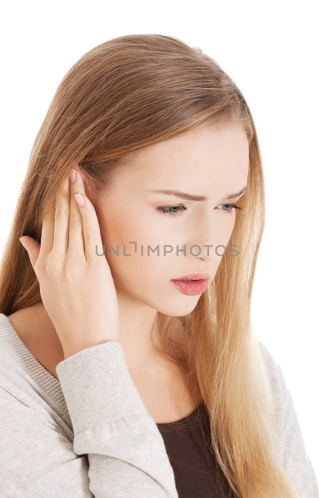 Beautiful casual woman is touching her ear. Health concept. Isolated on white.