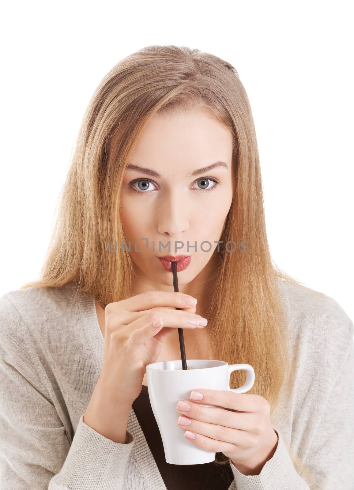 Beautiful woman is drinking from a cup with a straw. Isolated on white.