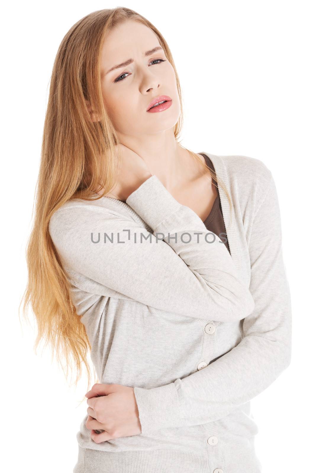 Beautiful casual woman is touching her neck. by BDS