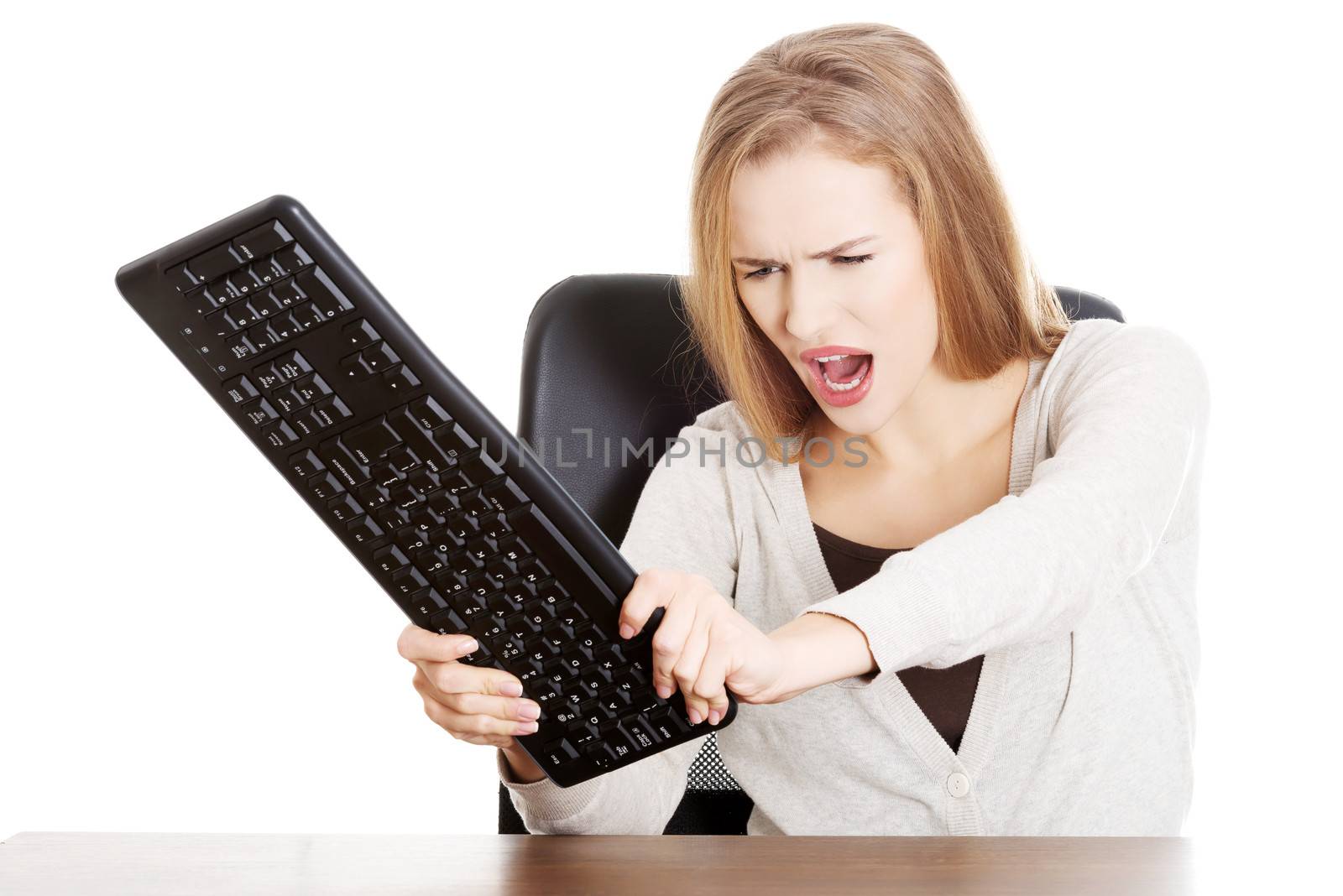 Beautiful casual woman trying to destroy keyboard. by BDS