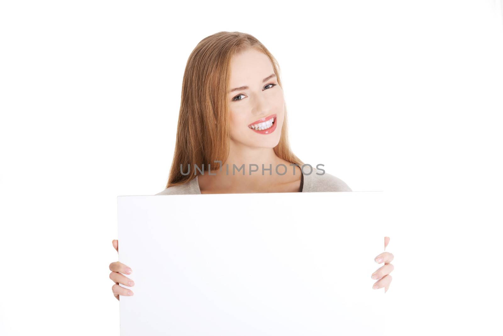 Beautiful casual woman holding copy space and advertising. by BDS