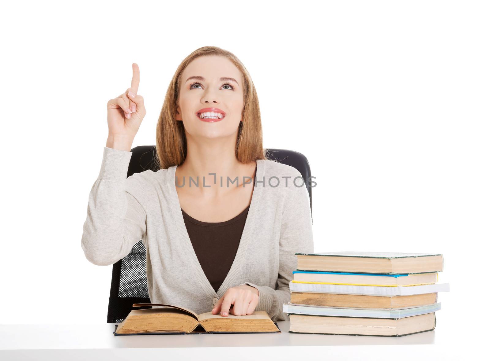 Beautiful casual student woman sitting by stack of books and poi by BDS
