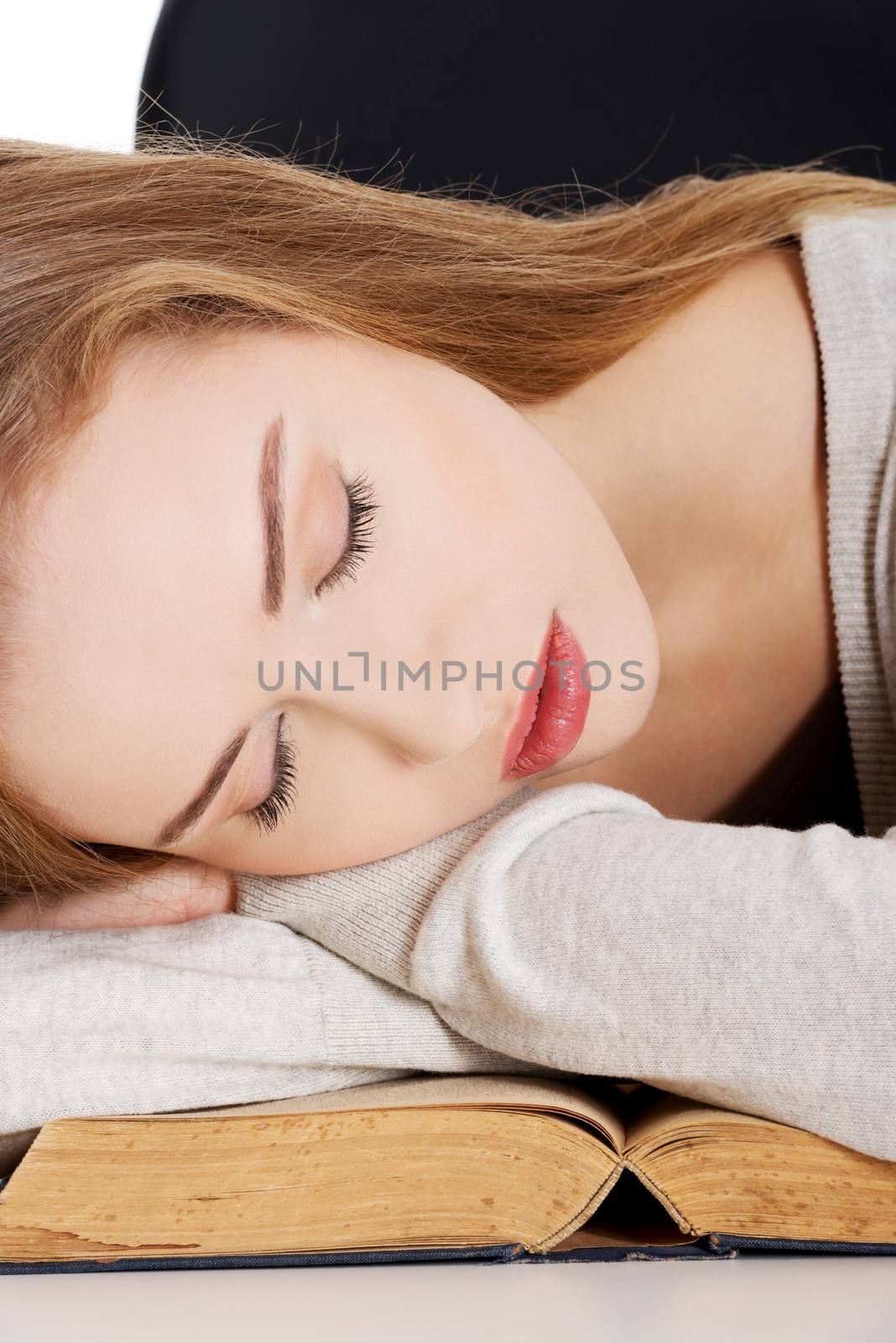 Beautiful woman is sleeping on a book. by BDS