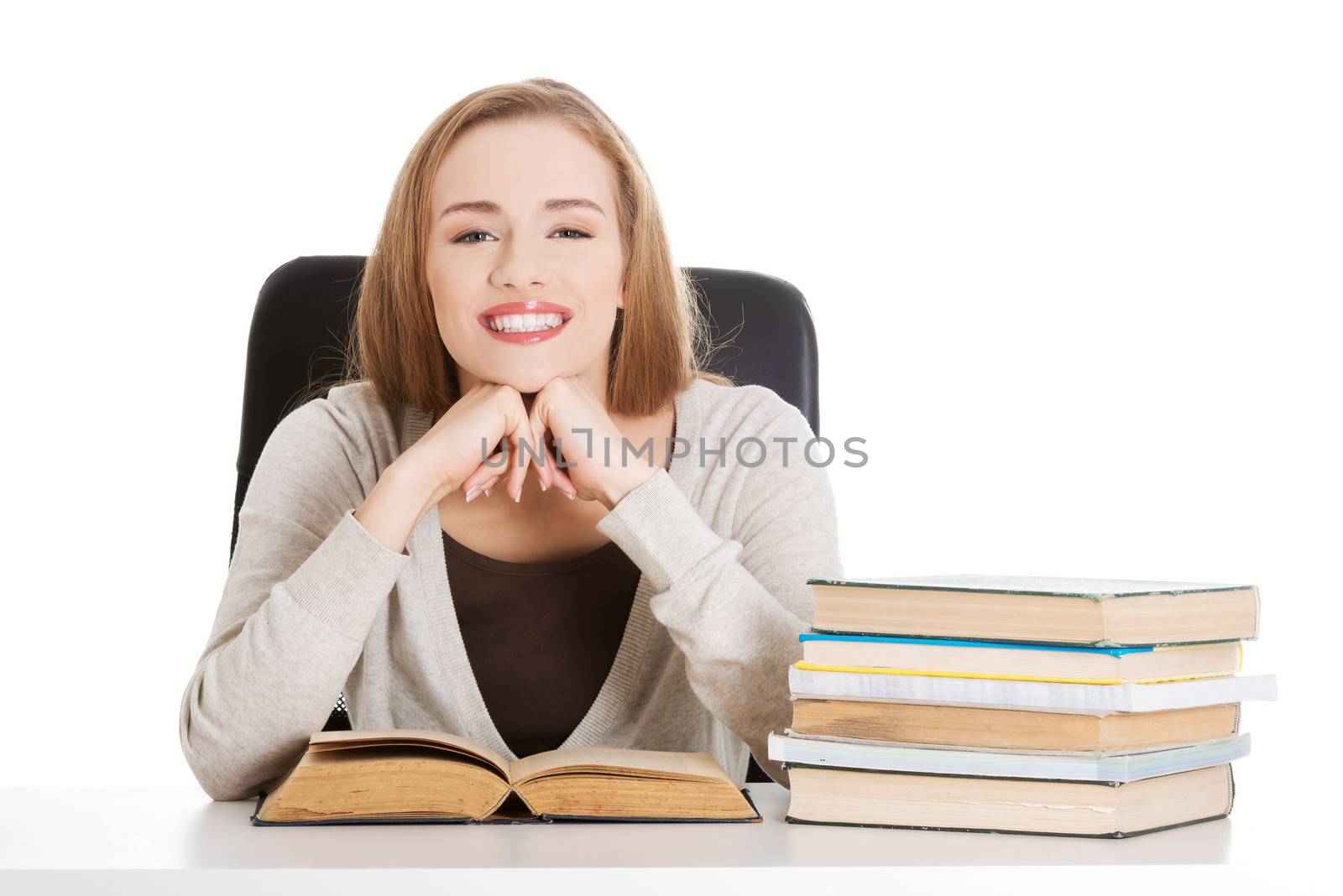 Beautiful student woman sitting by the desk with books and learn by BDS