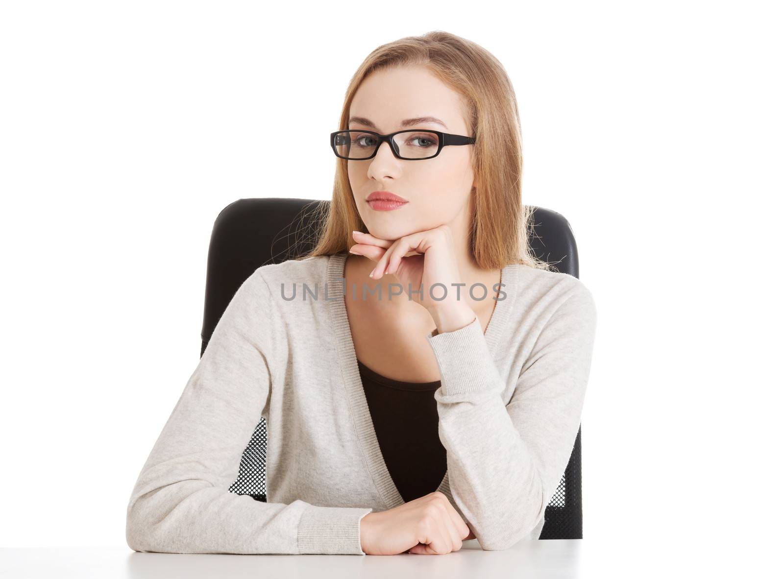 Portrait of beautiful attractive woman in eyeglasses. She's sitting by a desk. Isolated on white.
